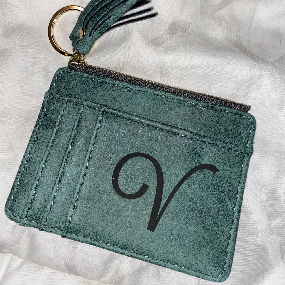 Coin darker green wallet with engraved letter “V”